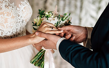 Husband holds wife's hand